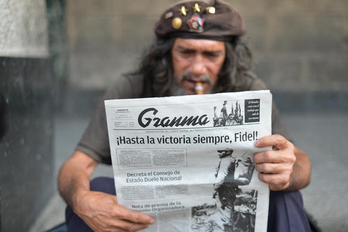 مرد کوبایی در حال خواندن روزنامه در فردای درگذشت کاسترو – هاوانا
