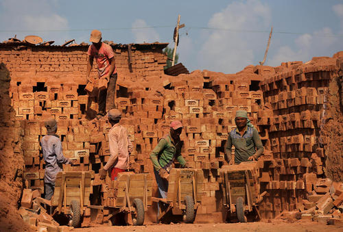 کارگران مهاجر مشغول کار در یک کارگاه آجرسازی در کشمیر