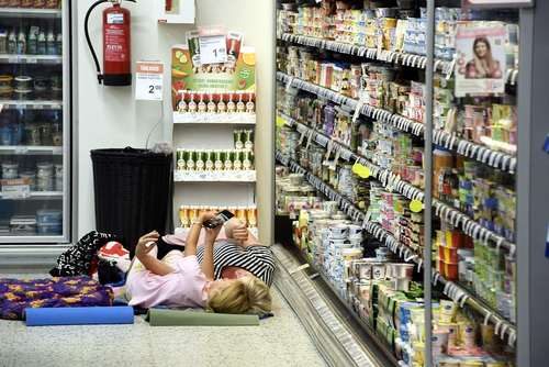 فروشگاهی در شهر هلسینکی فنلاند به دلیل گرمای هوا اجازه می‌دهد مشتریان در مقابل یخچال و در هوای خنک استراحت کنند./ خبرگزاری فرانسه