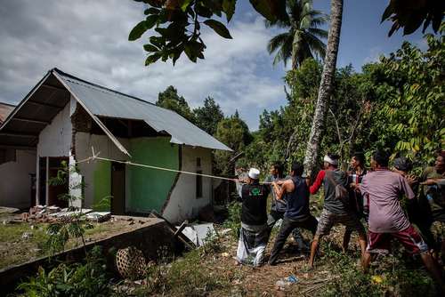 خراب کردن خانه‌های صدمه دیده از زلزله در جزیره لومبوک اندونزی
