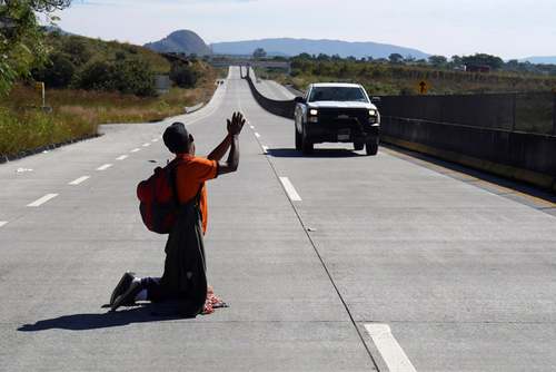 یک مهاجر آمریکای مرکزی در حال تلاش برای سوار شدن به ماشین‌هایی که به سمت مرز ایالات متحده آمریکا حرکت می‌کنند./مکزیک/ رویترز